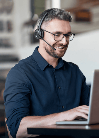Guy on laptop wearing Leitner LH270 Wireless Headset