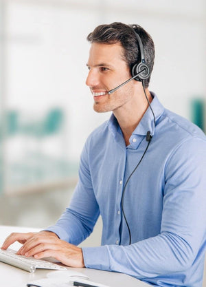Business man in blue shirt using OfficeHero single-ear corded headset- work from home headsets, office headsets