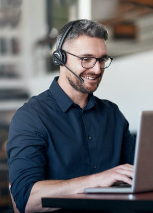 Man using OfficeAlly wireless headset on laptop- headset for computers, office headset, headset for laptops